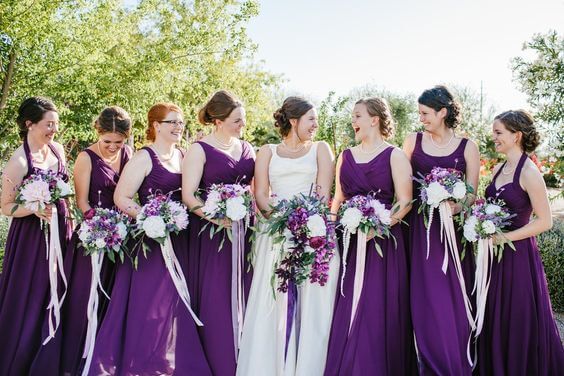White bridal gown and purple bridesmaid dresses for purple october wedding