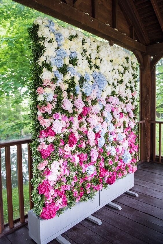 blue and pink flower wall for summer blue wedding