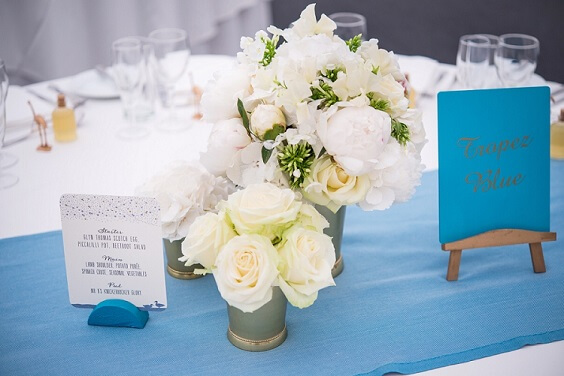 blue tablecloth and white flower centerpieces for summer blue wedding