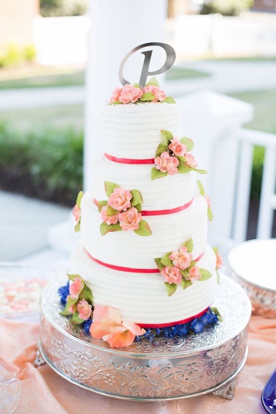 white wedding cake with peach flowers for summer royal blue wedding
