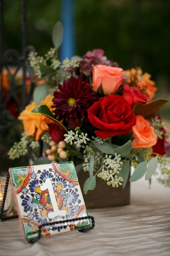 table card and flowers for november maroon and yellow wedding 2019