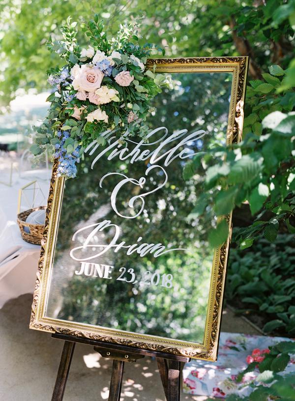 Welcome board for dusty blue and blush summer wedding