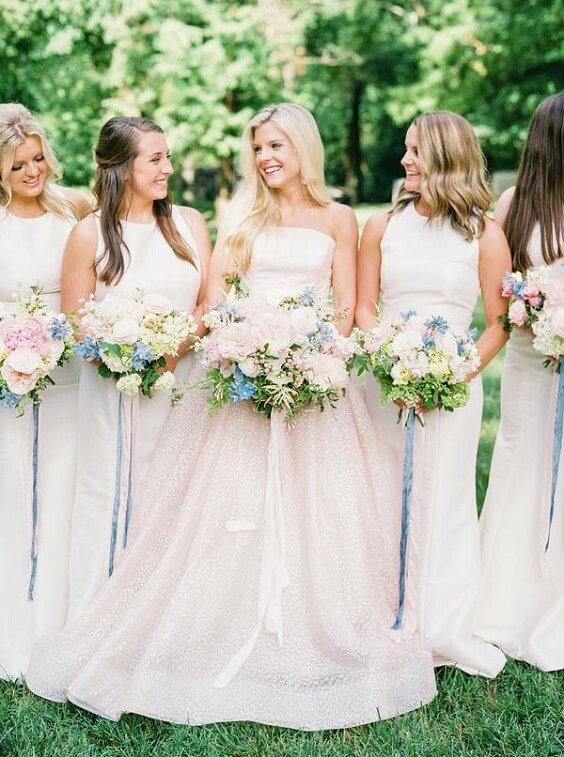 Blush bridal gown and white bridesmaid dresses for white and pink March wedding