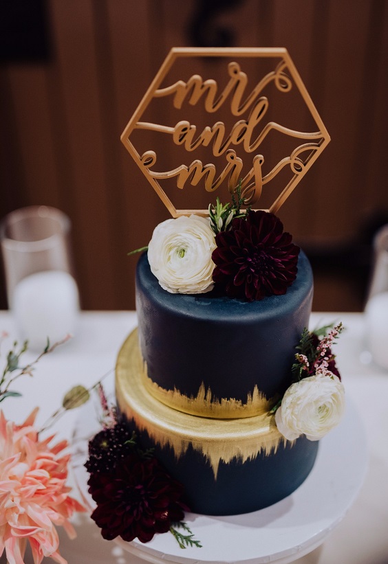 navy blue and golden wedding cake dotted with burgundy flowers for january wedding colors 2022 burgundy and navy blue