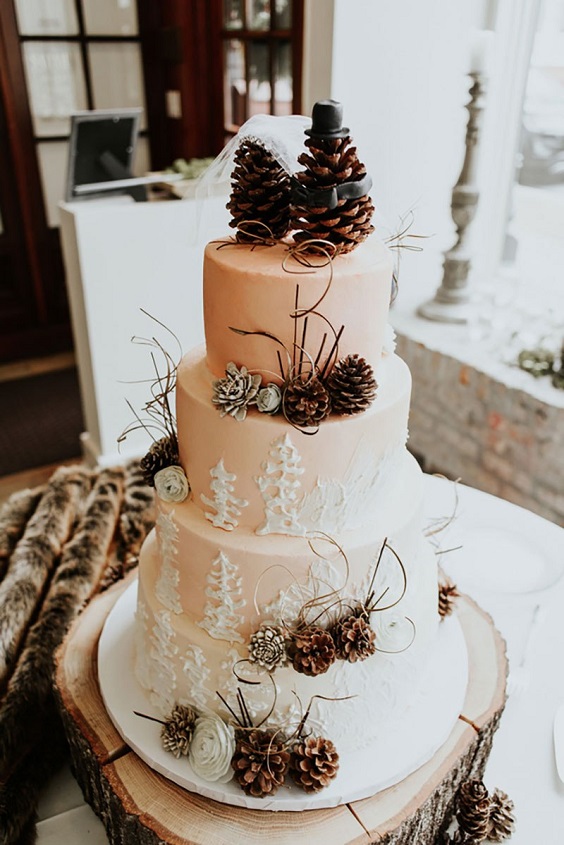 white wedding cake dotted with pinecone for january wedding colors 2022 neutral colors