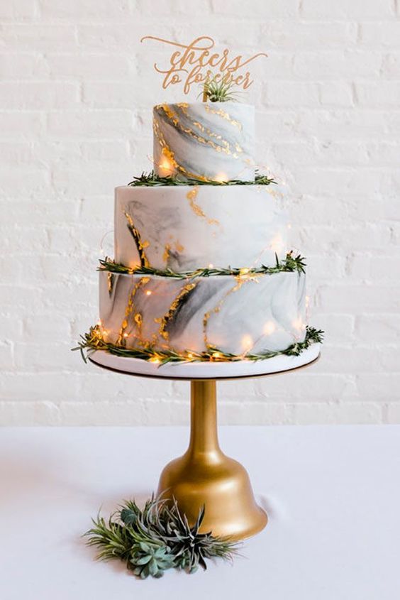 wedding cake with golden accent for march wedding colors 2022 ivory and gold