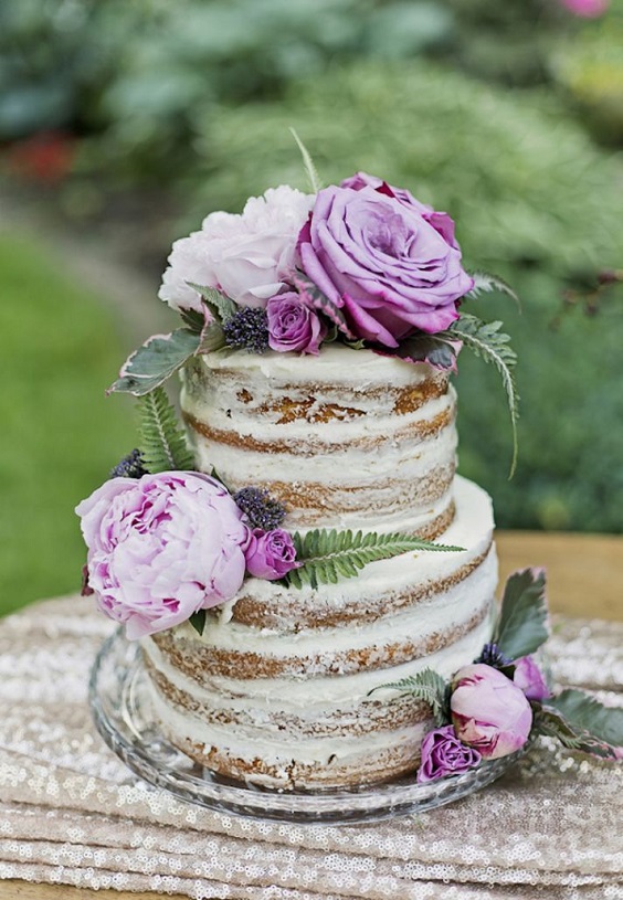 wedding cake dotted with purple flowers for April wedding colors 2022 shades of purple colors