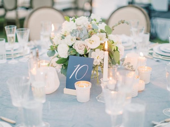 white wedding centerpiece with blue table number cards for April wedding colors 2022 white and blue colors