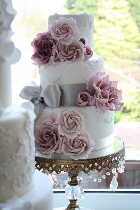 white wedding cake with mauve flowers and grey ribbons for summer wedding color 2022 mauve and grey colors