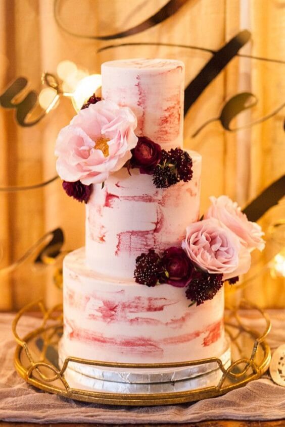 blush wedding cake with plum flowers for winter wedding colors 2022 plum and blush