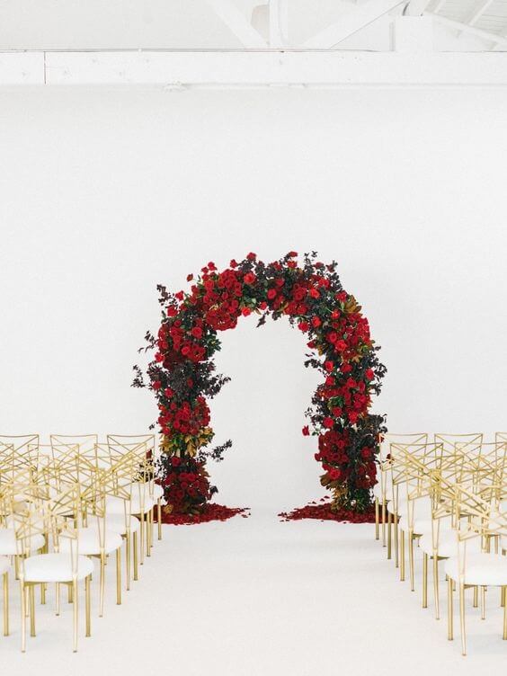 red rose wedding arch and gold white chairs for winter wedding colors 2022 red and gold