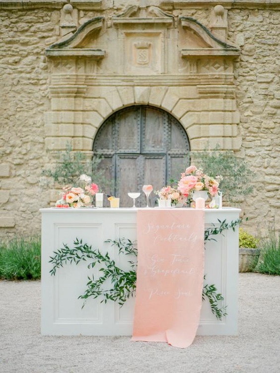 white wedding cake doracted with coral yellow flowers for spring wedding colors 2022 light blue coral yellow colors