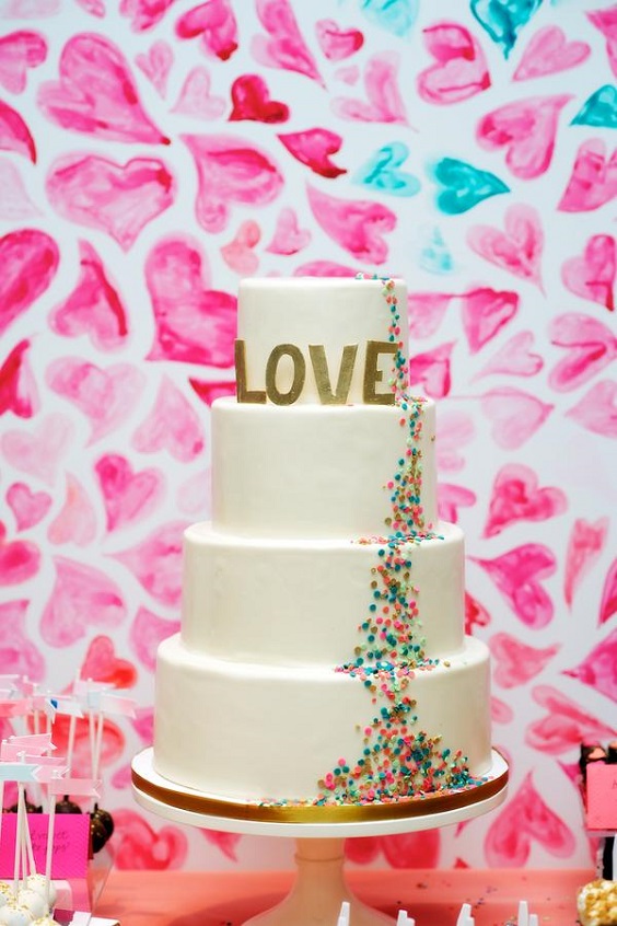 wedding cake with gold letter for sping wedding colors 2022 fuschia turquoise gold colors