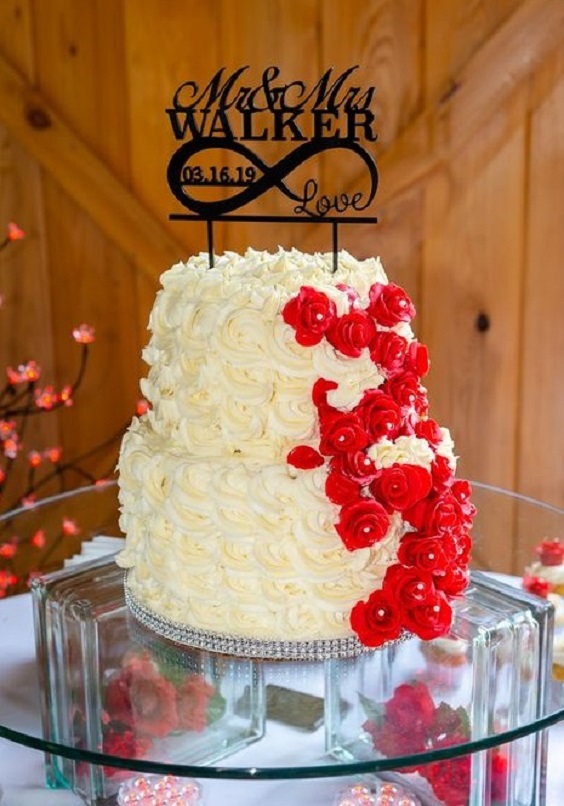 yellow wedding cake dotted with red flowers for fall wedding colors 2023 red and yellow