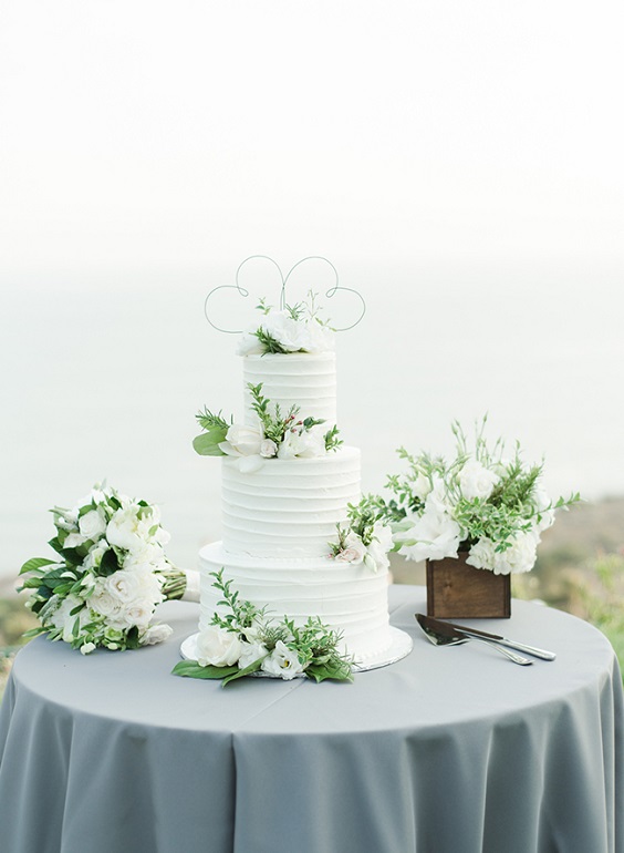 white wedding cake in wedding table with grey tablecloth for sage green wedding colors 2023 sage green and grey