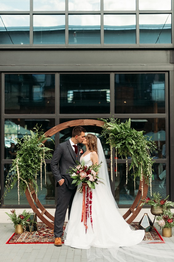 wedding arch with sage greenery for sage green wedding colors 2023 sage green and burgundy