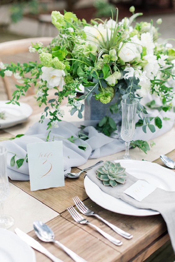 dusty blue napkins and sage greenery for sage green wedding colors 2023 sage green and dusty blue