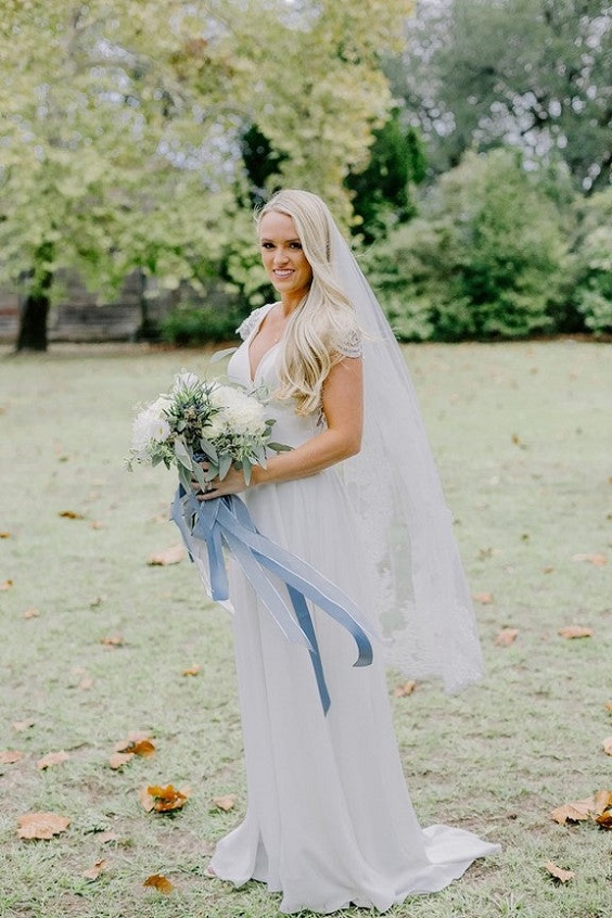 white and greenery bouquets with dusty blue ribbons for sage green wedding colors 2023 sage green and dusty blue