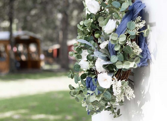 white flower greenery wedding decoration with dusty blue cloth for sage green wedding colors 2023 sage green and dusty blue