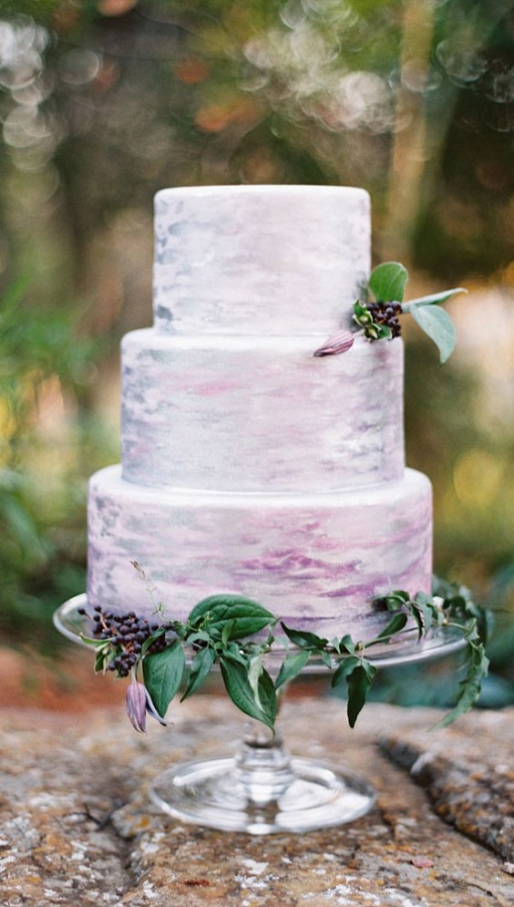 white and lavender wedding cake dotted with sage greenery for sage green wedding colors 2023 sage green and lavender
