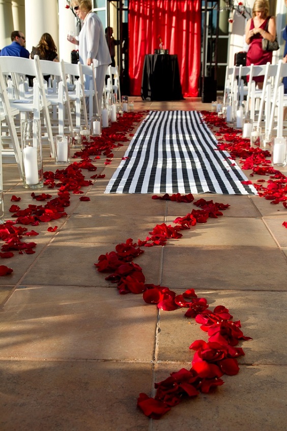 white chairs rose flowers aisle and black table linen for red and black wedding colors red black and white