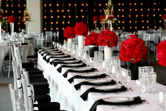 white tablecloth black napkin and red flower centerpiece for red and black wedding colors red black and white