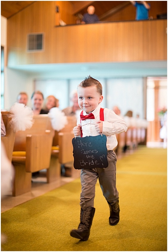 boys in grey pants and black shoes red bowties to welcome the bride for red and black wedding colors red black and grey