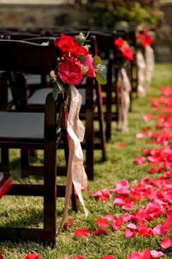 black wedding chairs tied with red flowers and champagne ribbons for red and black wedding colors red black and champagne