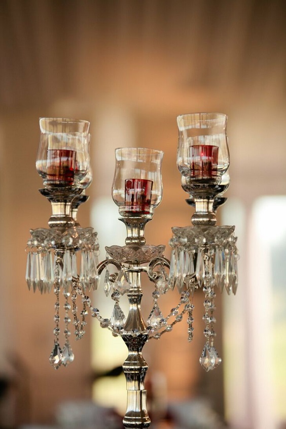 silver candelabras with red votives inside for red and black wedding colors red black and silver