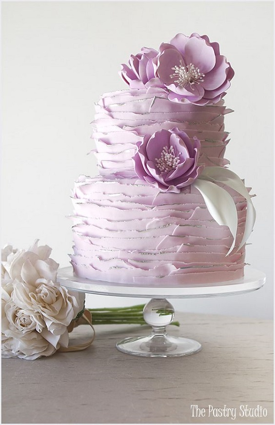 lilac wedding cake dotted with lilac and white flowers for purple wedding colors 2023 lilac and white