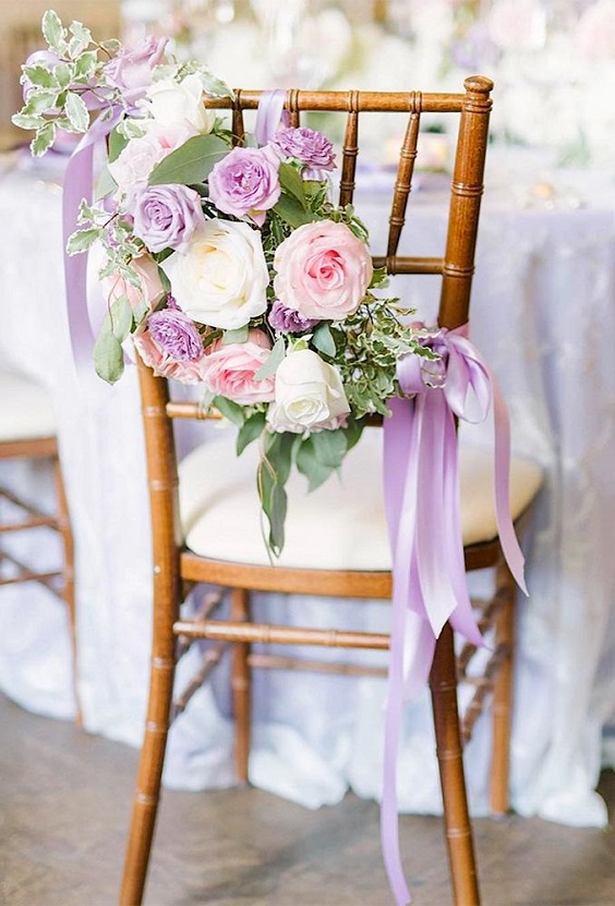wedding chair deocrated with lilac white and peach flowers and lilac sash for purple wedding colors 2023 lilac and white