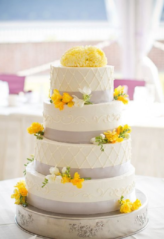 wedding cake dotted with yellow flowers for purple wedding colors 2023 purple and yellow