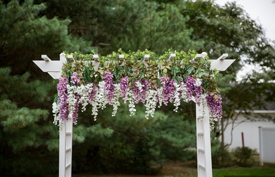 wedding arch with purple and lavender flower and greenery for purple wedding colors 2023 purple and grey