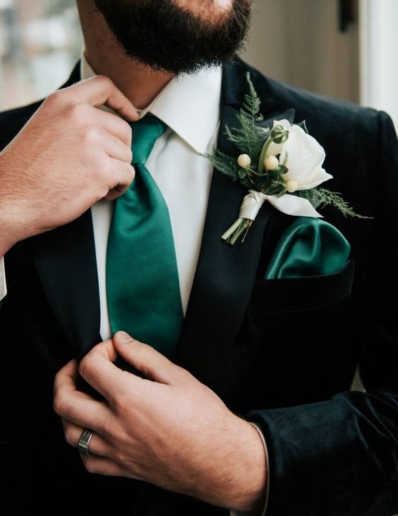 black mens suit and emerald green tie for winter wedding colors 2023 emerald green and gold