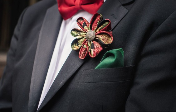 men's suit with red bowtie and green cloth boutonniere for red wedding colors 2023 red and green