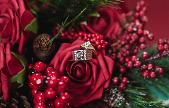 wedding ring hiding in red roses and green pines for red wedding colors 2023 red and green