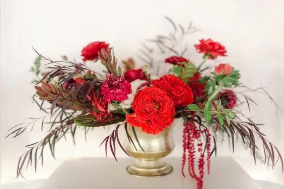 red flowers in gold vase for red wedding colors 2023 red gold and white