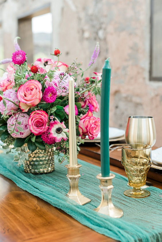 hot pink flower centerpiece emerald table runner and gold candle vase and cup décor for august wedding colors 2023 emerald hot pink and gold