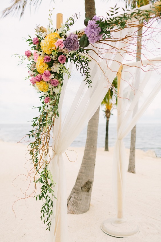 lavender yellow pink flower and greenery wedding arch for august wedding colors 2023 lavender and yellow