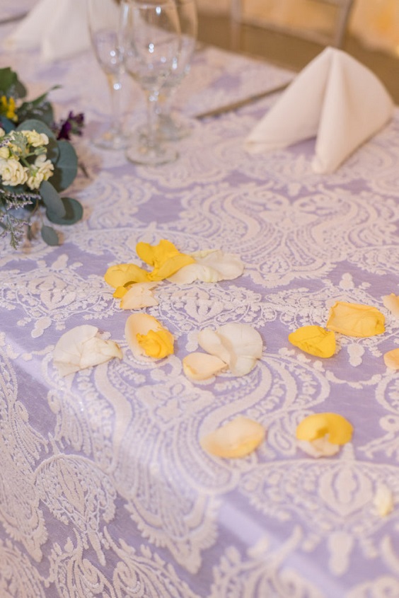 white and lavender lace wedding tablecloth with yellow flower petals décor  for august wedding colors 2023 lavender and yellow