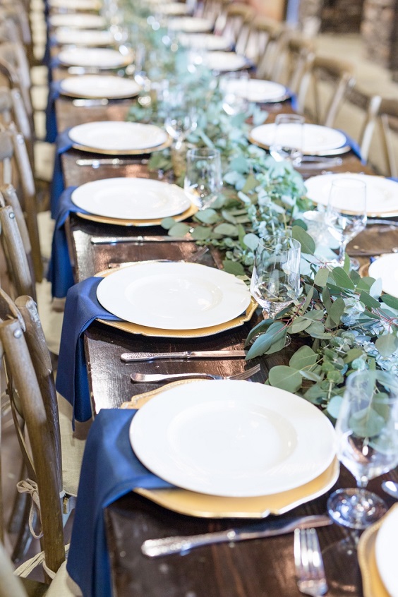 white wedding plate navy napkin and greenery decoration for august wedding colors 2023 navy white and greenery