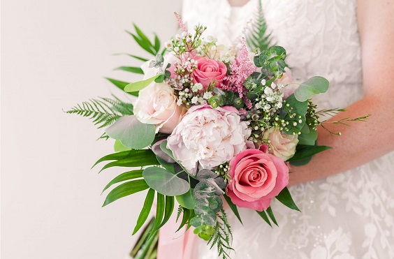 hot pink and light pink flowers and green leaves bridal bouquet for august wedding colors 2023 shades of pink and grey
