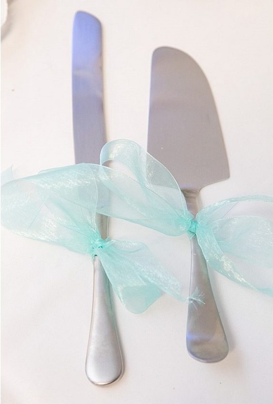 wedding knife and forks tied with tiffany blue ribbons for blue wedding colors 2023 tiffany blue gray and coral