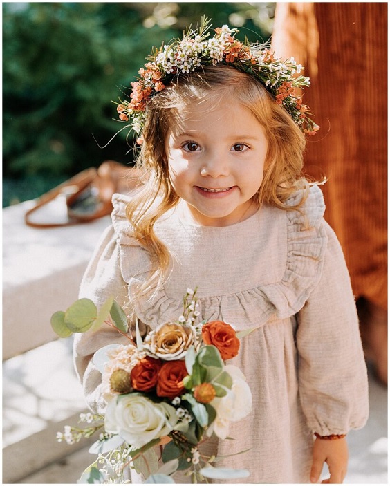 flower girl with rust terro cotta flower for november wedding colors 2023 rust and terro cotta