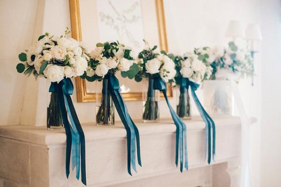 white flower and greenery wedding bouquets with navy blue and light blue sashes for november wedding colors 2023 shades of blue