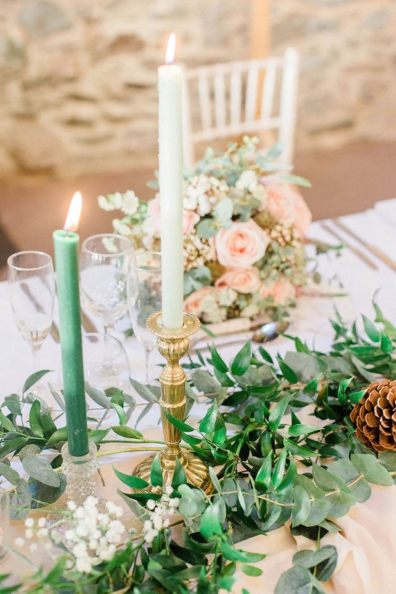 peacock candle in white crystal candlesticks in wedding table for green wedding theme 2023 peacock green colors