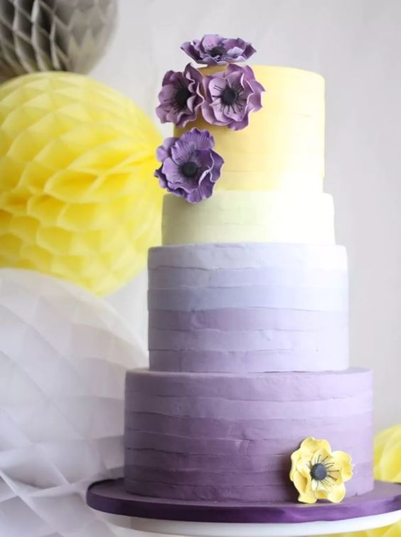 lavender and yellow wedding cake dotted with lavender and yellow cream flower  for april wedding color schemes for 2023 lavender and yellow
