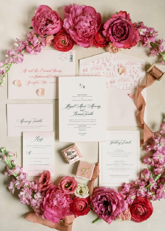 wedding stationery circled with red and pink flowers for april wedding color schemes for 2023 shades of pink and red