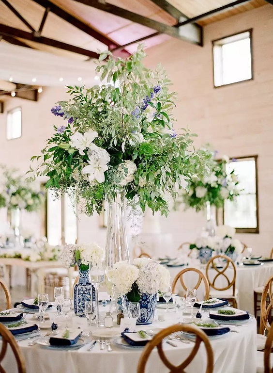 flowers of wedding centerpieces in blue and white porcelain vase and navy blue wedding napkins for april wedding color schemes for 2023 shades of blue