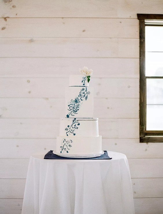 white wedding cake with royal blue flower cream for april wedding color schemes for 2023 shades of blue